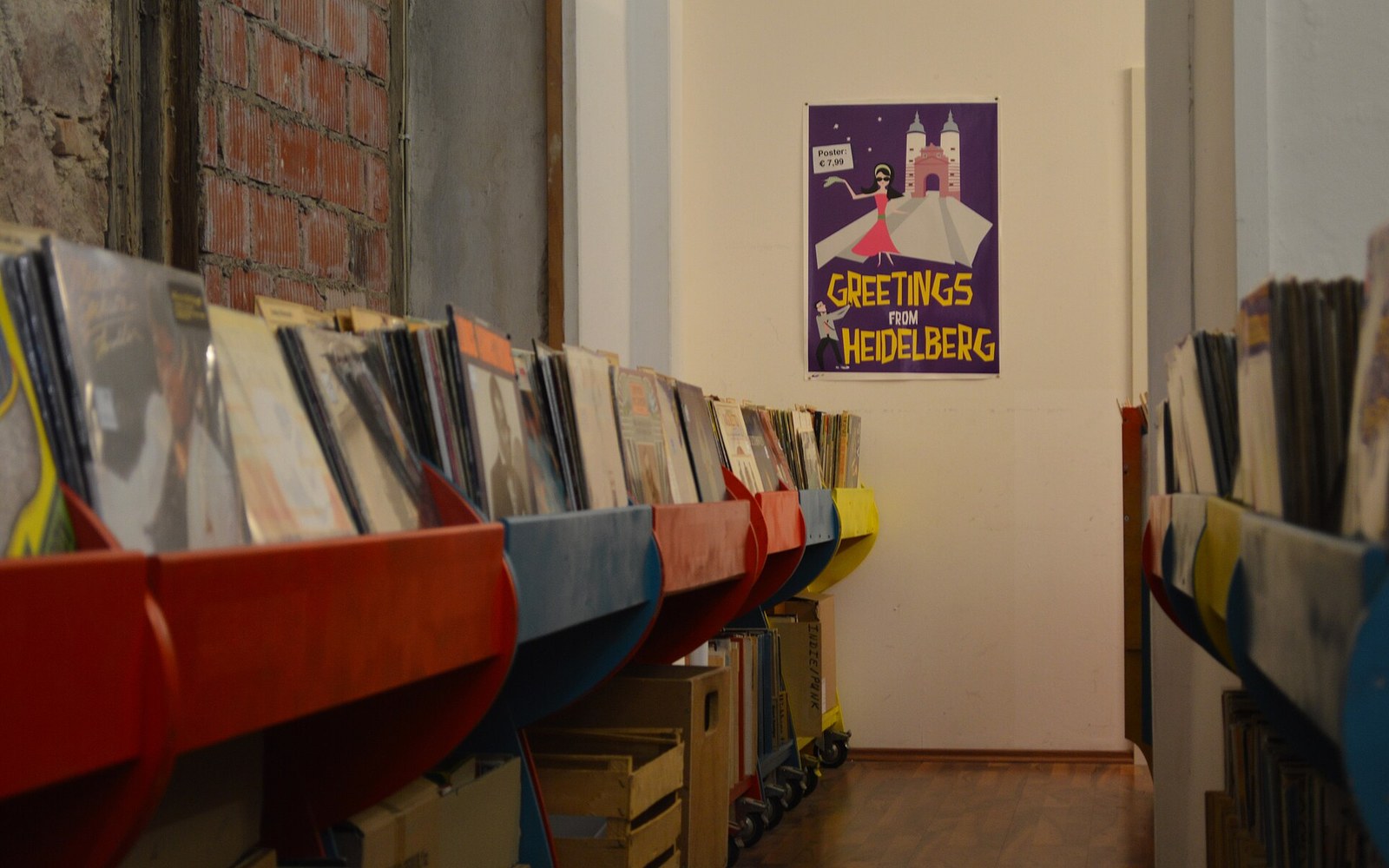 A record shop rack of sleeves seen edge-on under strip lighting