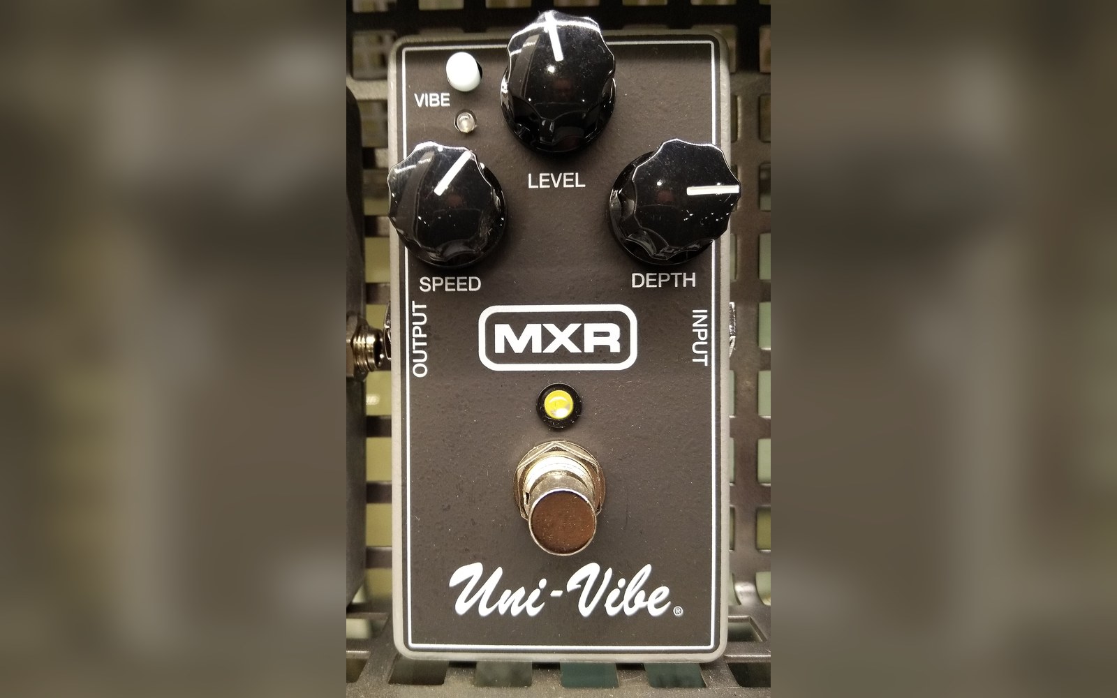 A period effects pedal photographed straight on